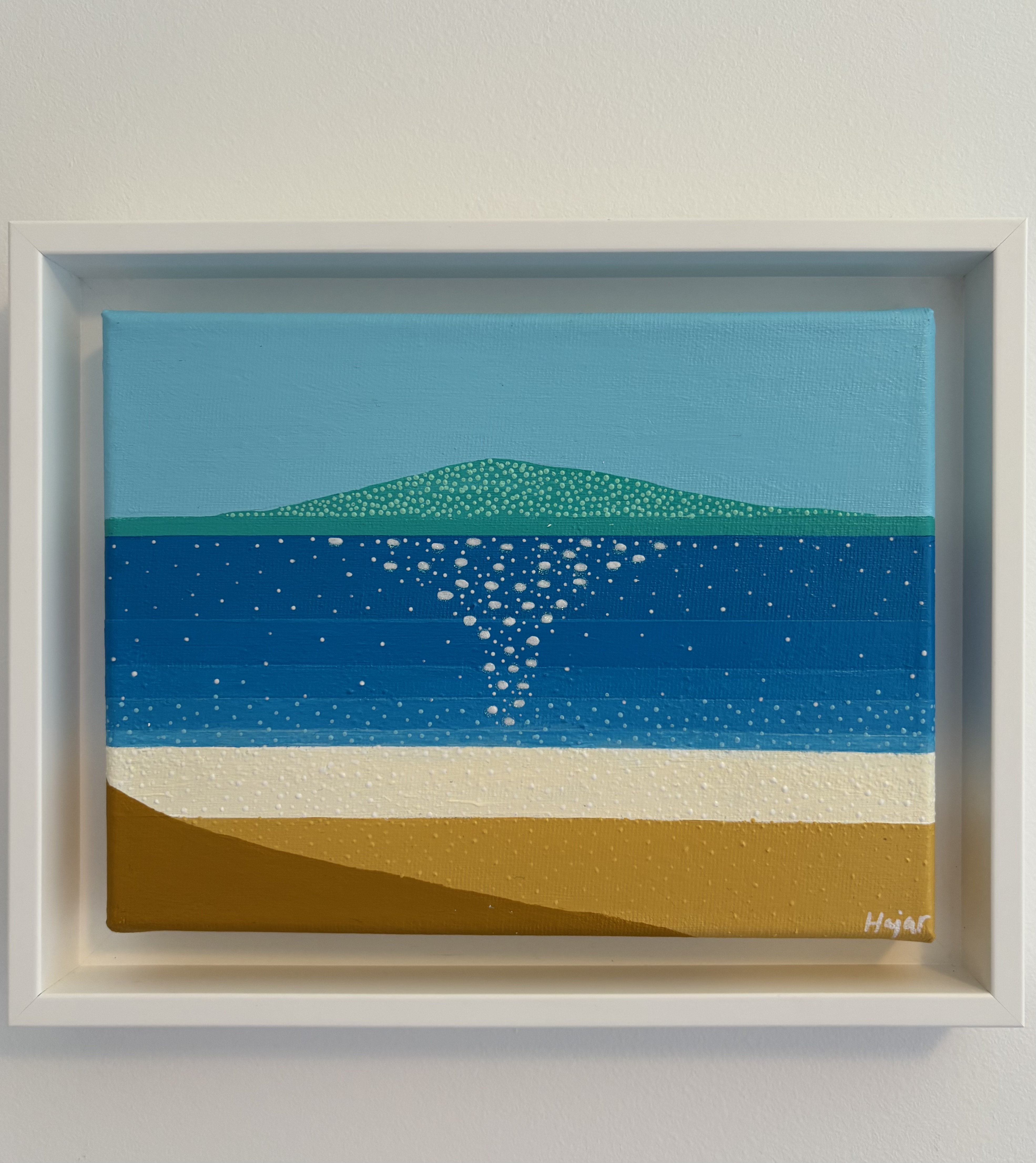 Across the Quiet Water - distant green island on the horizon with bands of blue water and white shoreline
